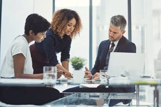 Three colleagues- in discussion at an office desk-thumbnail