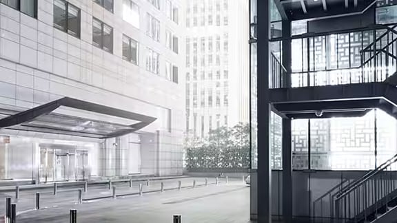 Grayscale image of the parking lot stairwell outside a commercial building