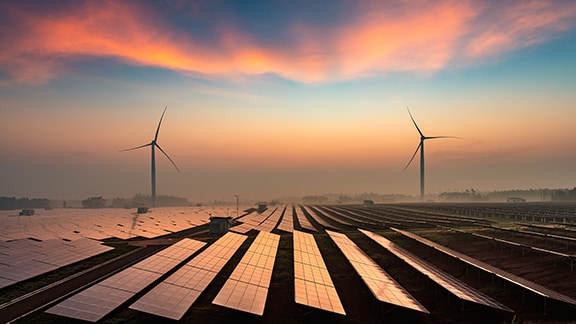 A wind turbine farm at sunset